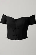 Blusa DF01790 con moños para mujer, silueta ajustada, elaborada en poliéster dyaboo color negro